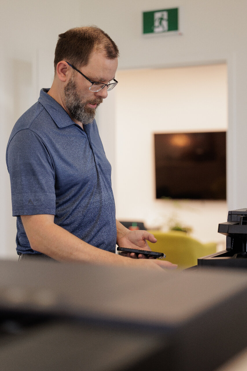 Service Technician troubleshooting a Kyocera Multifunction Printer